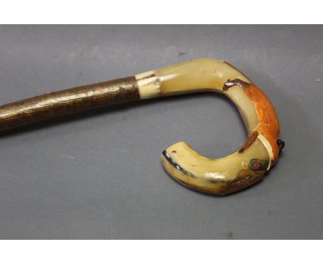 A rams horn handled walking stick, with carved pheasant and fox on a hazel shaft, length 121 cm.