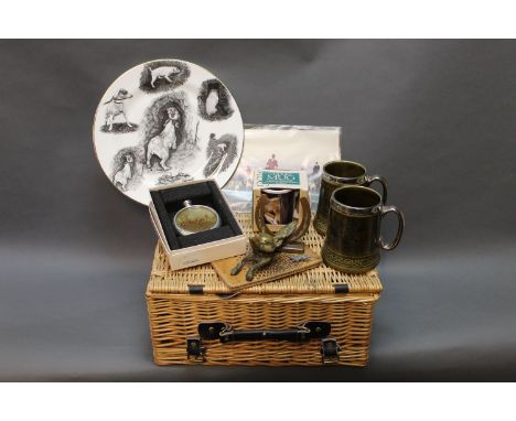 A picnic basket containing a MacDonald fox hunting plate, hunt photograph, mugs, brass fox door knocker, hip flask etc.