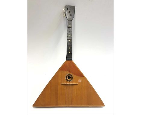 A Russian three-stringed balalaika, bearing interior label with printed Cyrillic script.