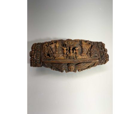 An early 19th-century French coquilla nut snuff box carved all over with a wealth of religious symbolism 101mm