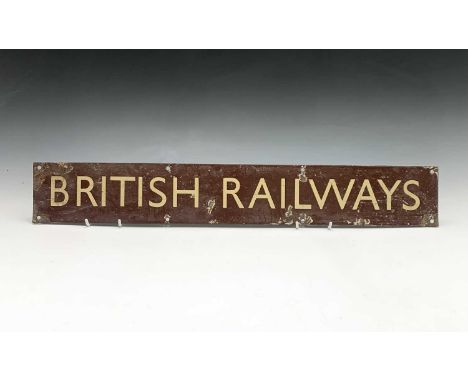 Railwayana - A brown enamel sign with cream lettering 'BRITISH RAILWAYS' . 10cm x 68.5cm.