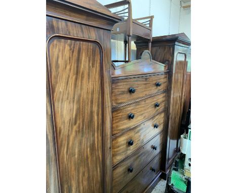 A William IV figured mahogany veneered wardrobe chest, with architectural cornices, the central section fitted five long draw