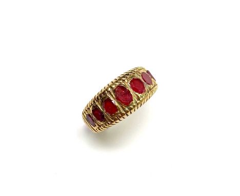 A very high purity yellow gold ring set with graduated mine cut rubies 12.5gm