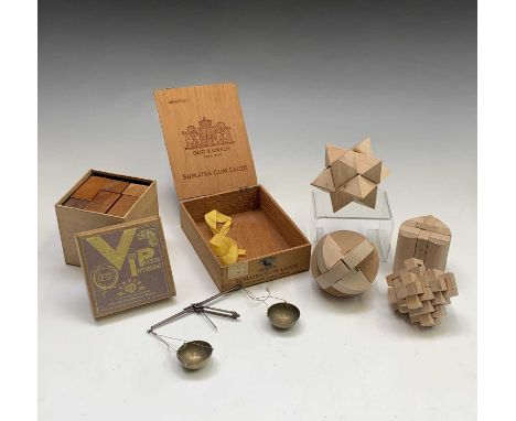 Five assorted wooden puzzles and a small set of scales.