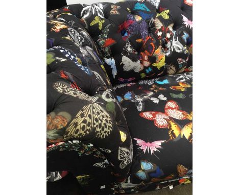 A Chesterfield style three seater sofa covered in Matthew Williamson butterfly print fabric (cost £2500 new). Width 238cm.