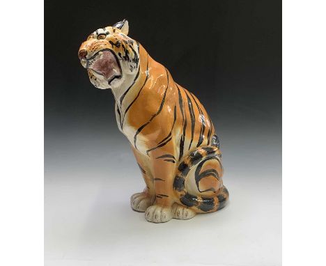 A large ceramic model of a seated tiger. Height 53cm.