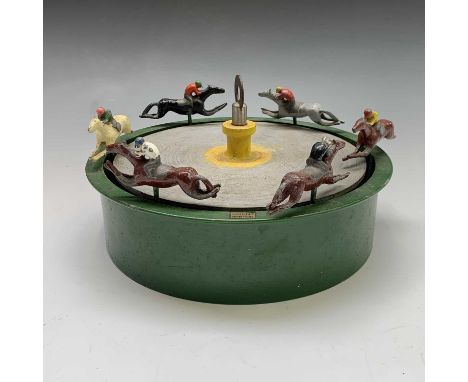 A vintage painted lead and diecast horse racing game, with spinnig turntable and six painted horse and jockey figures, diamet