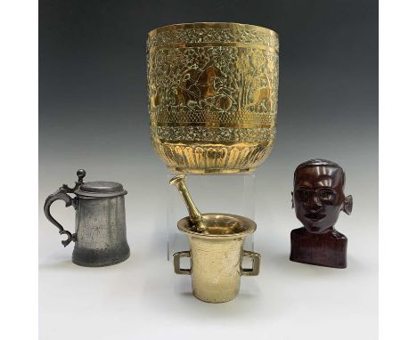 An Indian brass jardiniere, embossed with a stag hunting scene, height 23cm together with and a pestle and mortar, a carved h