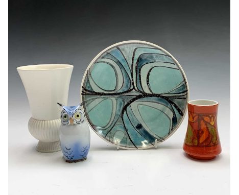 A Poole pottery plate painted with an abstract design, diameter 20cm, a Poole small vase, a Wedgwood vase, and a porcelain ow