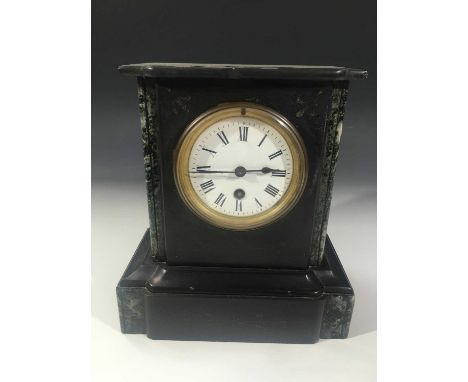 A black slate and marble mantle timepiece, with white enamel dial, fitted a French movement, height 25cm.