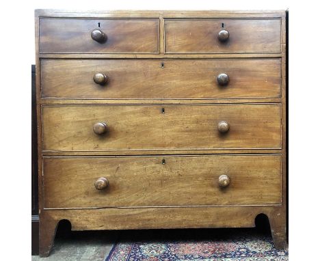 A 19th century mahogany chest of two short and three long drawers, with turned wooden handles on bracket feet, height 106cm, 