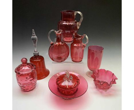 A collection of Victorian cranberry glass to include a celery vase, jugs and dishes, together with a ruby glass bell. Height 