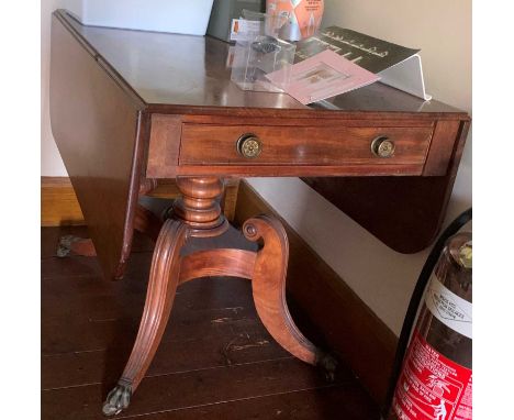 A Regency mahogany Pembroke table, fitted two end drawers, raised on ring turned pillar on a concave sided base with four sab