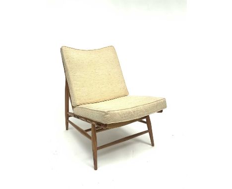 A scarce Ercol model 427 beech lounge chair with remnants of original label, with loose squab cushions.
