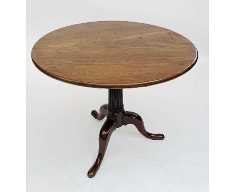 An early George III mahogany tilt top pedestal table, the plain circular top on a birdcage action with tapering fluted pillar