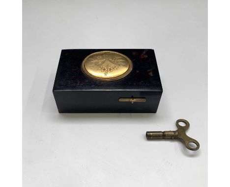 A late 19th-century singing bird musical box, with plain tortoiseshell case, the automaton bird rises from beneath a lovebird