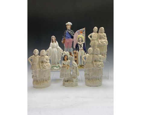 A Victorian Staffordshire figure modelled as a sailor holding a flag, another figure of the Virgin Mary and the Serpent, two 