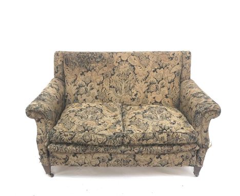 An Edwardian two seat upholsted sofa raised on square legs and castors, length 134cm. Provenance: From Penrose House, the Pen