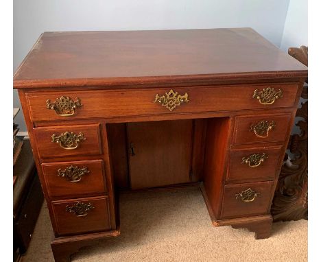 A late George II mahogany kneehole dressing chest or desk, fitted with a long drawer above six graduated short drawers, and a