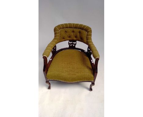 Edwardian arm-chair with green upholstery, button-backed.