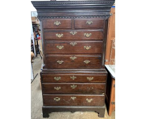 An early George III country made oak chest on chest, with Greek key cornice above an arcaded frieze, the upper part with two 