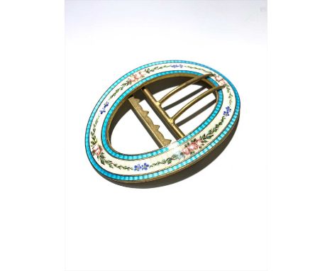 A large gilt and enamel oval buckle.