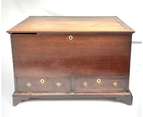 A good early George III mahogany linen storage chest, of Chippendale inspiration, with rising lid and twin side carrying hand