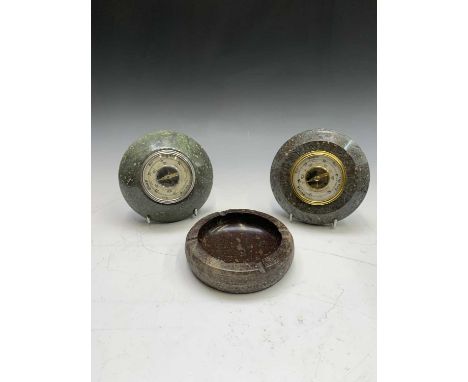 Two Cornish serpentine framed barometers together with a serpentine ashtray of circular form, diameter 15.5cm (3).