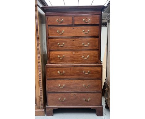 A George III mahogany chest on chest, with moulded dentil cornice, the upper part fitted two short and three long drawers wit