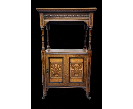 A Victorian burr walnut music cabinet possibly after Bruce Talbert, for Gillow &amp; Co, the upper part with patarae carved f