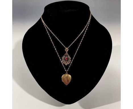 A 9ct heart locket and chain, a 9ct pendant set a red stone on chain, a gold and silver ring and 3 gold studs. 13gm