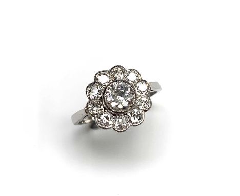 A very pretty diamond cluster ring with bright near colourless stones.