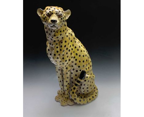A large ceramic model of a seated leopard. Height 78cm.