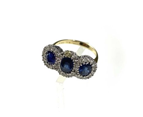 An 18ct gold sapphire and diamond triple cluster ring