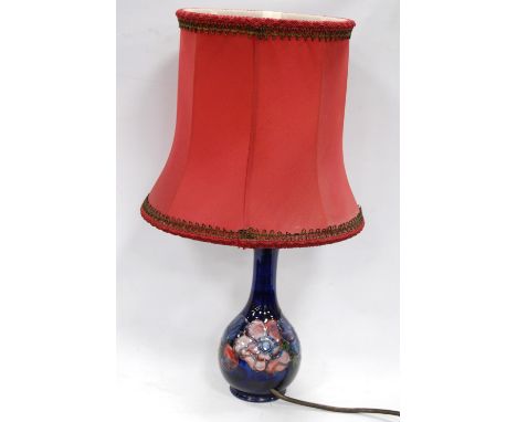 Moorcroft anenome pattern bottle-shaped table lamp with blue ground, 46cm overall.