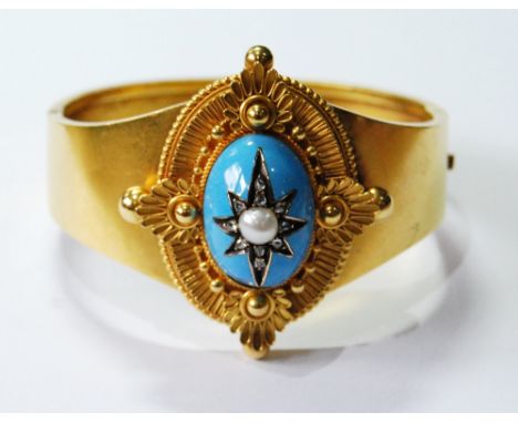 Victorian gold hinged bangle with beaded and ribbed oval centre with diamond and pearl-set star upon blue enamel boss. Condit