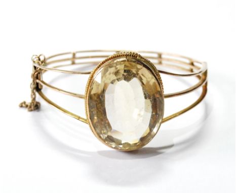 Victorian gold hinged bangle with oval cairngorm upon triple wires. Condition Report This is c. 1900.  It is 27.5g gross.  Pr