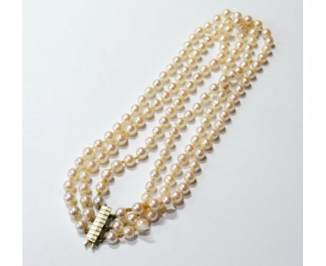 Cultured pearl three-row necklet on gold strap, '585'.