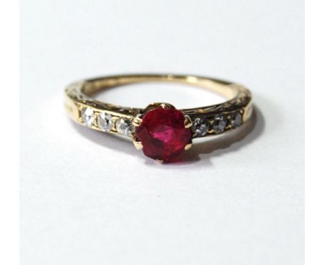 Solitaire ruby ring with six diamonds, in gold. Condition Report Gross weight 2.7g.  Diameter of the ruby is approximately 5m
