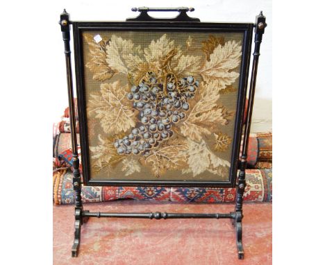 Victorian parcel gilt ebonised firescreen with vineous needlework panel, 105cm high.