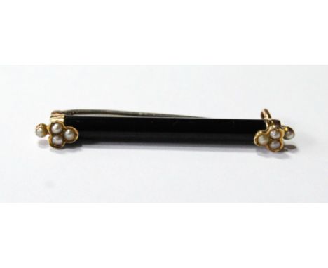 Onyx bar brooch with pearl-set gold terminals.