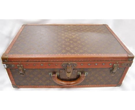 Vintage Louis Vuitton leather suitcase, with stamped brass fittings, the interior with numbered label 484984, lacks tray, 22c
