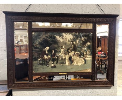 A Victorian carved walnut overmantel mirror with central panel housing a print "A chip off the old block", enclosed by four m