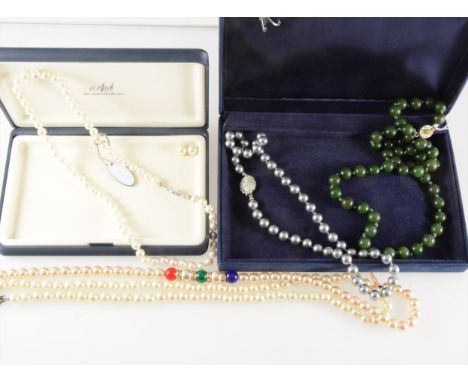 Three simulated pearl necklaces and a necklace of fifty-one green jadeite beads 54cm long. (Qty: 3)