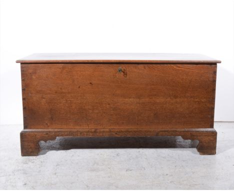 Late Georgian oak coffer, rectangular form with a hinged boarded lid, bracket feet, 121cm.
