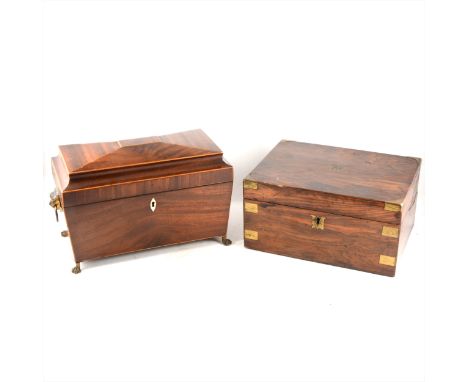 A Regency mahogany sarcophagus shaped tea caddy, strung outlines, leopard's head loose-ring handles, fitted interior, 36cm; a