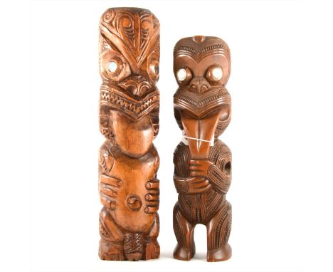 A well carved Maori figure with mother of pearl eyes H.36cm, and a similar figure H.41cm. (2)