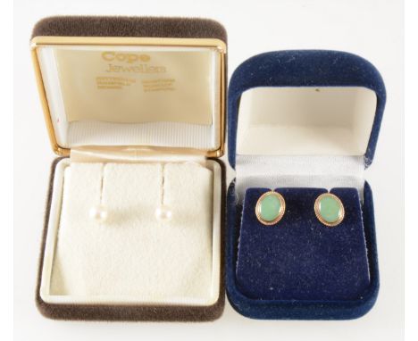 A pair of 7mm cultured pearl earstuds, a pair of oval cabochon cut jade earrings in 9 carat yellow gold rope edge mounts, bot
