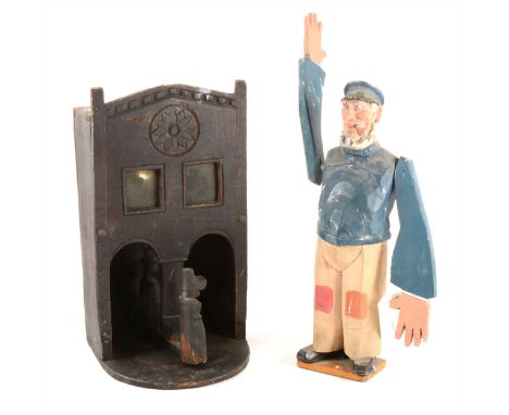 Folk Art, A Whirligig in the form of a pipe smoking sailor H.28cm, together with a wall bracket with revolving figures. (2)
