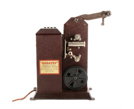 A Kodatoy vintage projector, Universal model, in a red cloth case.